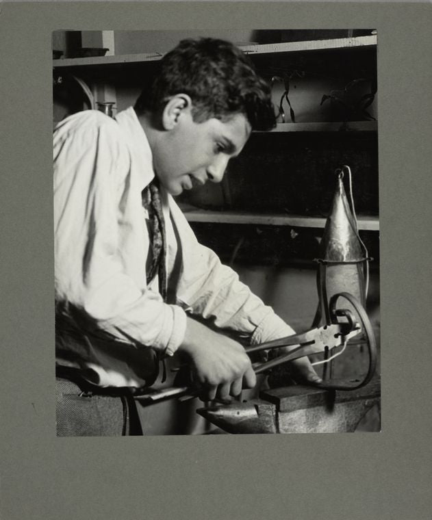 A boy making a wrought iron lamp in a Brooklyn school, 1925