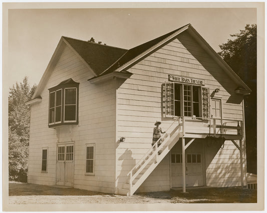 Exterior of the White Barn Theatre with Lucille Lortel on steps, ca. 1940s