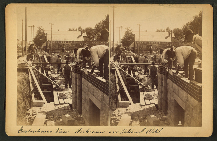 View of masons laying bricks on National Hotel in Salina.