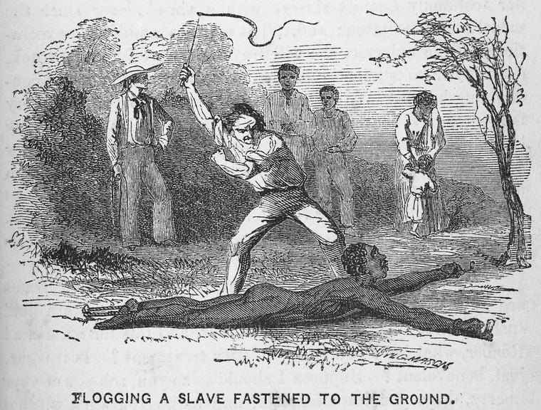 Flogging a slave fastened to the ground