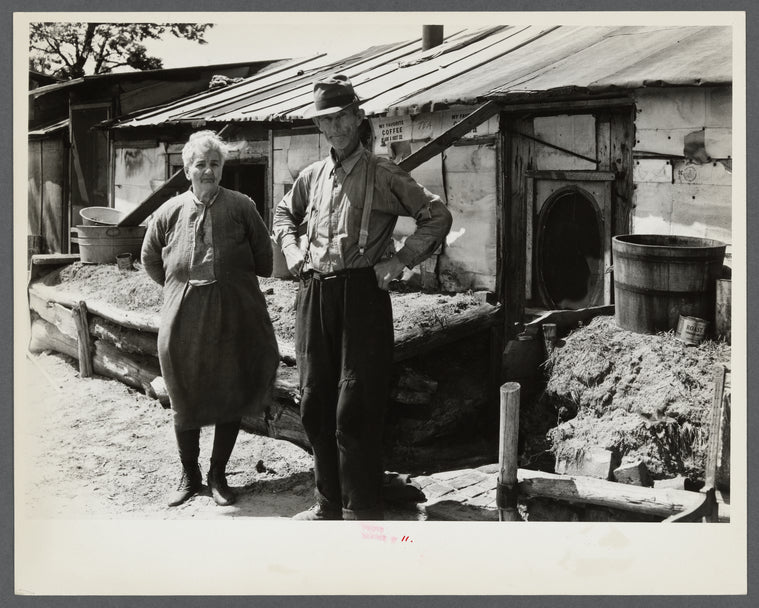 Mr. and Mrs. Thompson standing in front of their log and peat cabin. Thompson reckoned that he had had three crops out of nine on the land. Necedah project, Wisconsin.