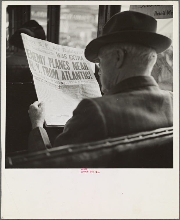 Reading war news aboard streetcar. San Francisco, California