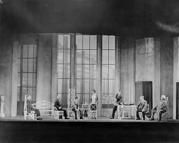 L to R: Henry Travers, Edgar Kent, Frederick Roland, Sylvia Field (standing), Earle Larimore, seated on table, Harry Mestayer and Sydney Greenstreet in R.U.R. Theatre Guild Tour Company Production, 1928-29. Set Designed by Lee Simonson.