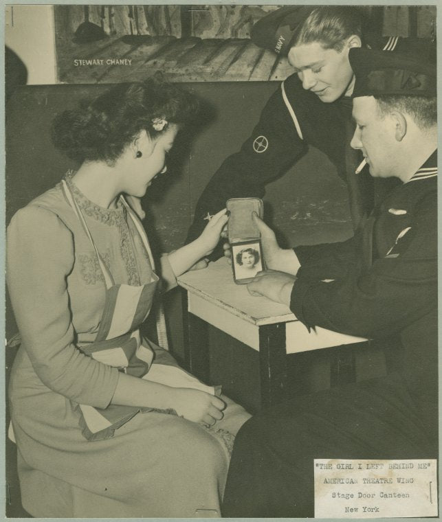 "The girl I left behind" - Service man shows a picture of a woman to hostess.