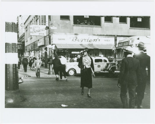 Woman crossing street in Harlem at West 125th Street and Eighth Avenue, 1939