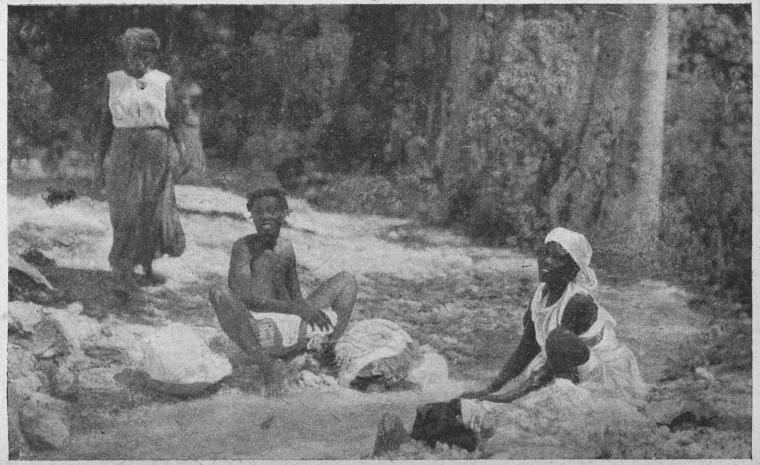 Haitian women washing clothes in a river.