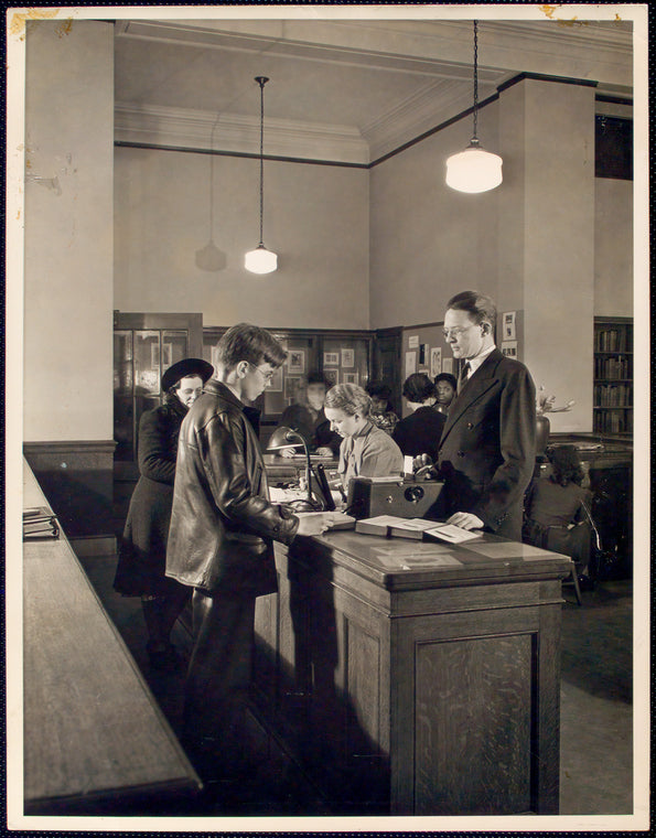 Librarian at desk with patron