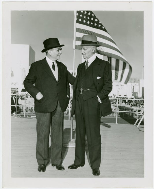 Fairgrounds - Visitors - Two men in front of flag