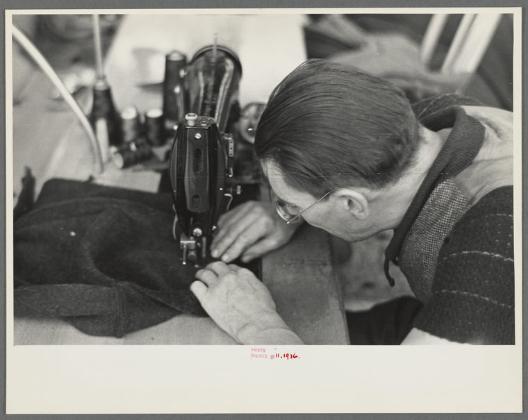 Closeup of man working sewing machine in garment factory, Jersey Homesteads, Hightstown, New Jersey