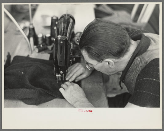 Closeup of man working sewing machine in garment factory, Jersey Homesteads, Hightstown, New Jersey