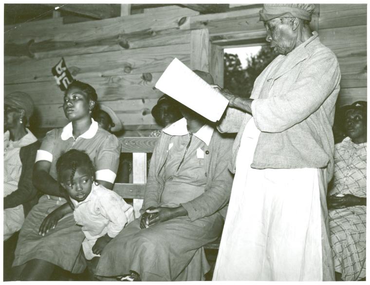 Star pupil, 82 years old, reading her lesson in adult class, Gee's Bend, Alabama, May 1939.