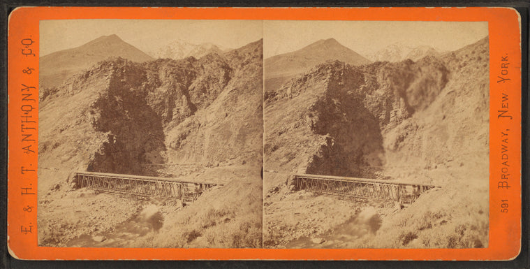 Devil's Gate from the south, the high peaks of the Wahsatch [Wasatch] in the distance. Union Pacific Railroad.