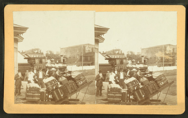 Men and baggage on station platform.