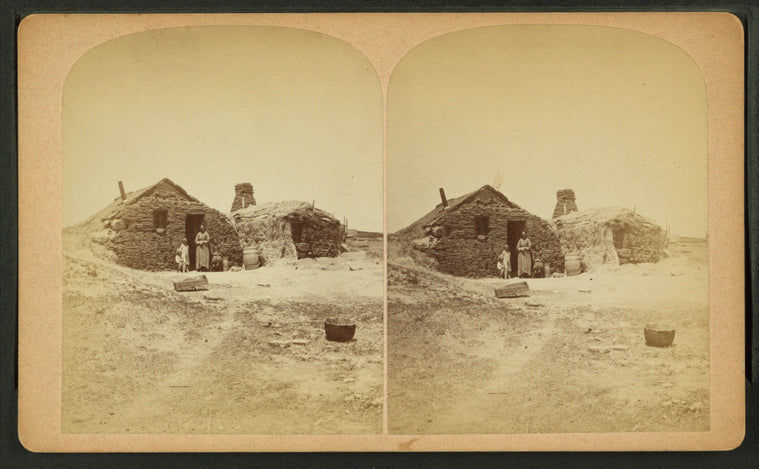 Family in front of a sod house.
