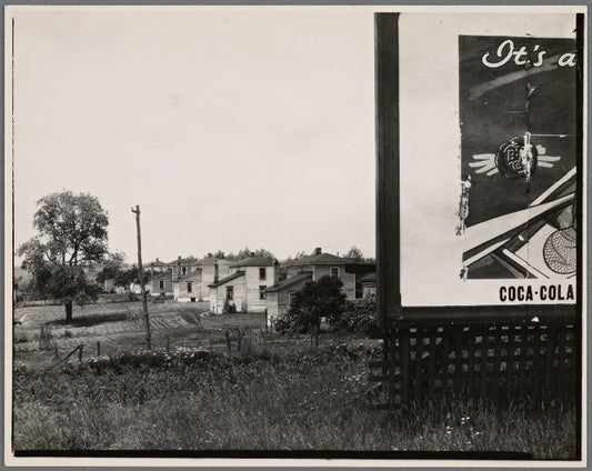 Houses with partial view of billboard advertising Coca-Cola in foreground. West Virginia?