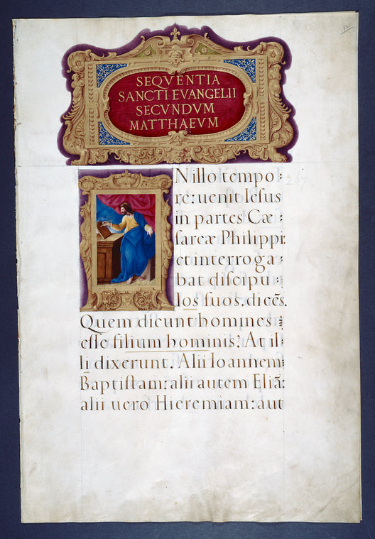 Opening of gospel of Matthew, who stands at his desk, writing; elaborate borders