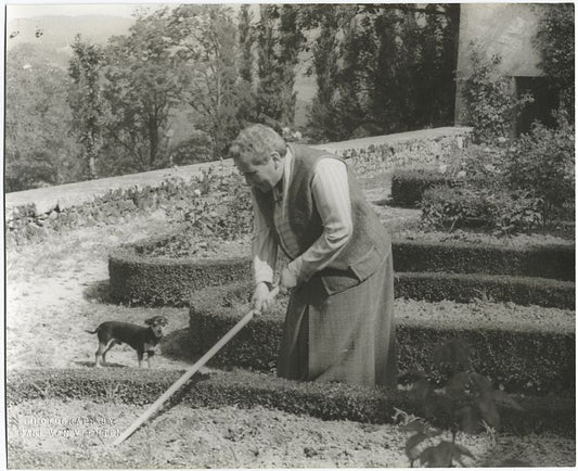 Gertrude Stein at the formal garden of her villa at Bilignin, with Pepe