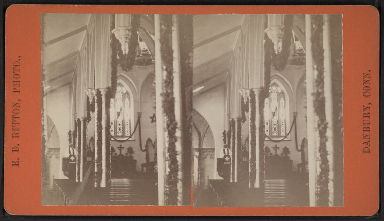 View of a garland-draped church interior with the pastor in the pulpit.