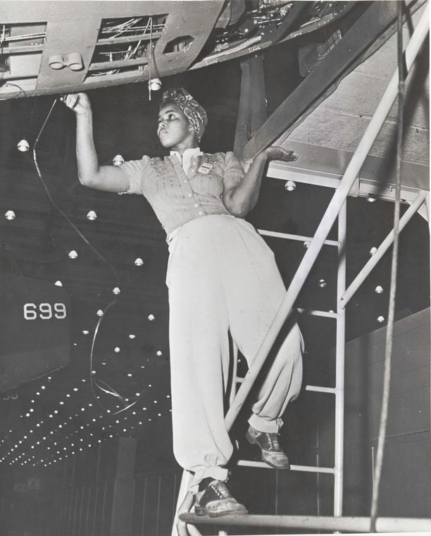 Workers of many races push plane output