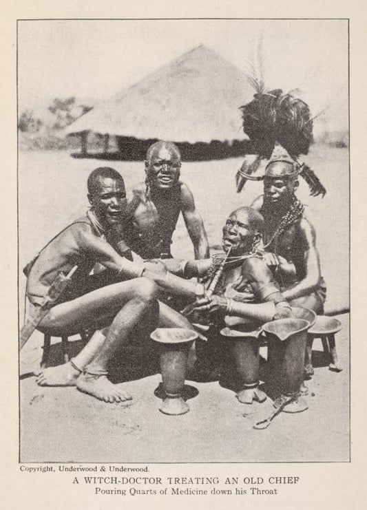 A witch-doctor treating an old chief [Pouring quarts of medicine down his throat.]