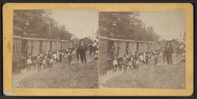 Men standing by railway cars.