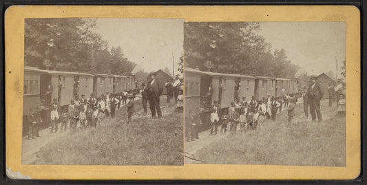 Men standing by railway cars.