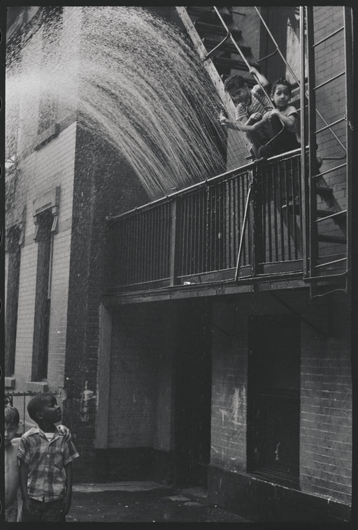 Boys playing on fire escape. New York, NY