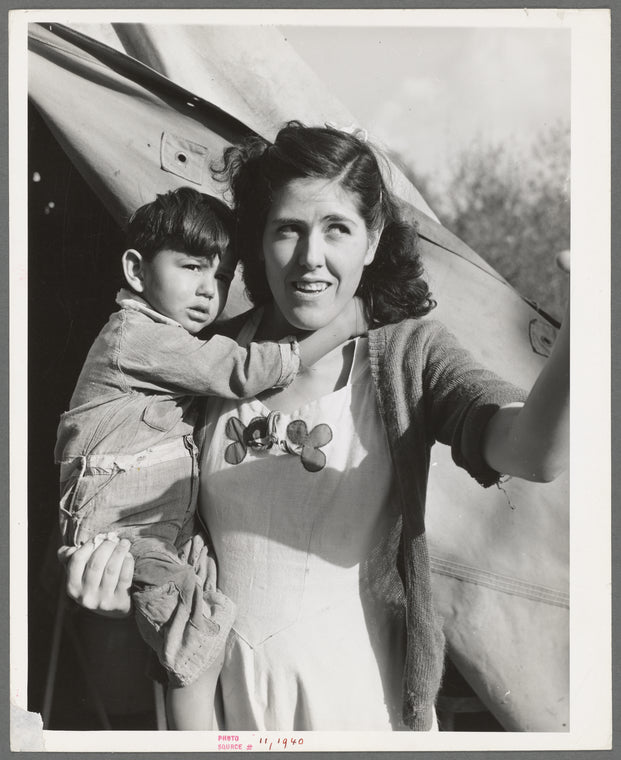 Mother and child in front of tent-home. This family is from Oregon. The man is a concrete worker. Mission Valley, California, which is about three miles from San Diego