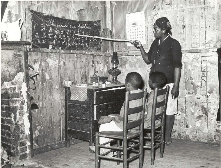 Negro mother teaching children numbers and alphabet in home of sharecropper, Transylvania, Louisiana, January 1939.