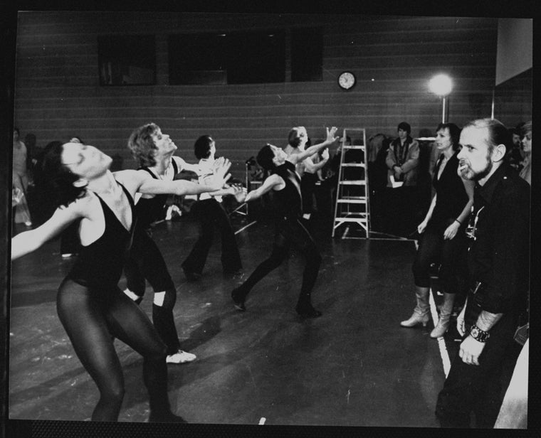 Director/choreographer Bob Fosse (R) watching with unidentified dancers during a rehearsal for the Broadway production of the musical "Dancin'.".