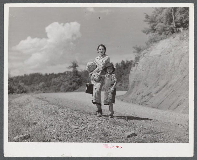 Mountain woman carrying home groceries from the store. Near Hyden, Kentucky.