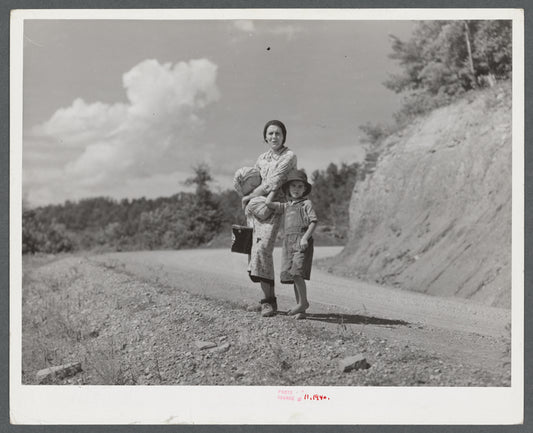 Mountain woman carrying home groceries from the store. Near Hyden, Kentucky.