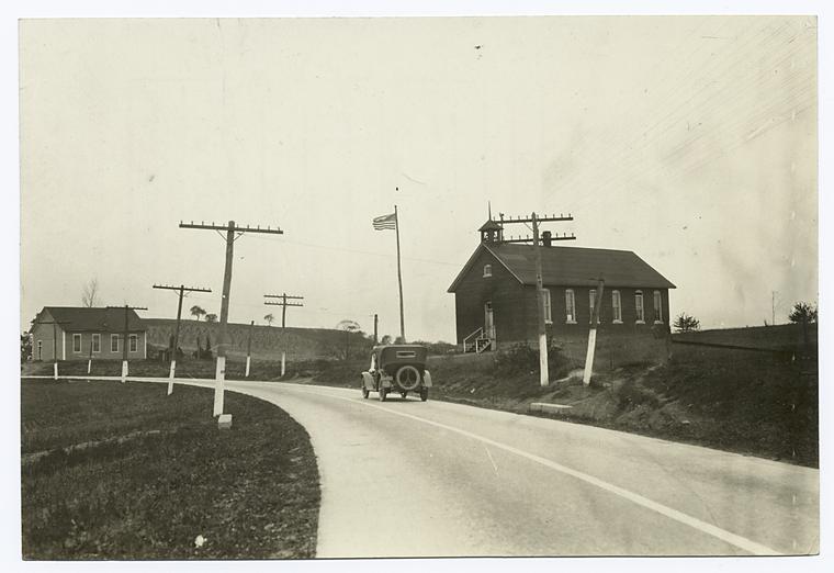 Paved road, car, and church