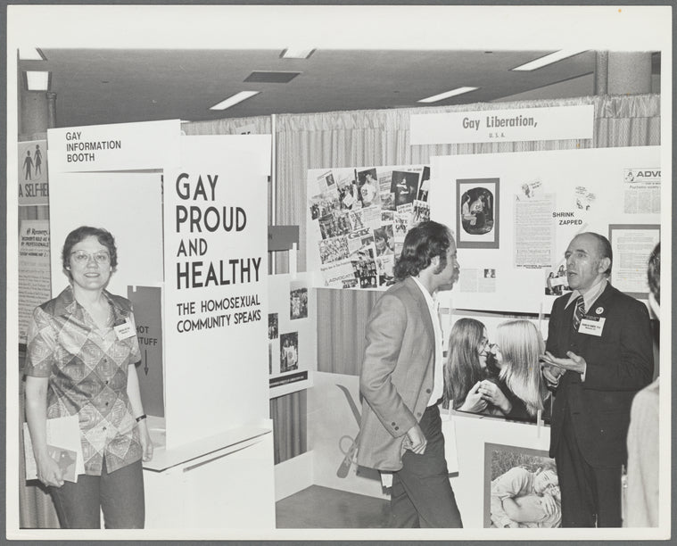 Kameny talking to psychiatrist at "Gay, Proud, and Healthy" display
