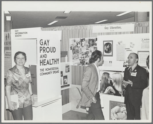 Kameny talking to psychiatrist at "Gay, Proud, and Healthy" display