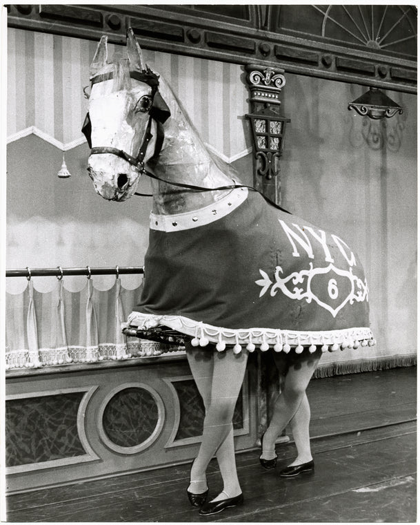 Performers wearing horse costume, from the Broadway production of Hello, Dolly!