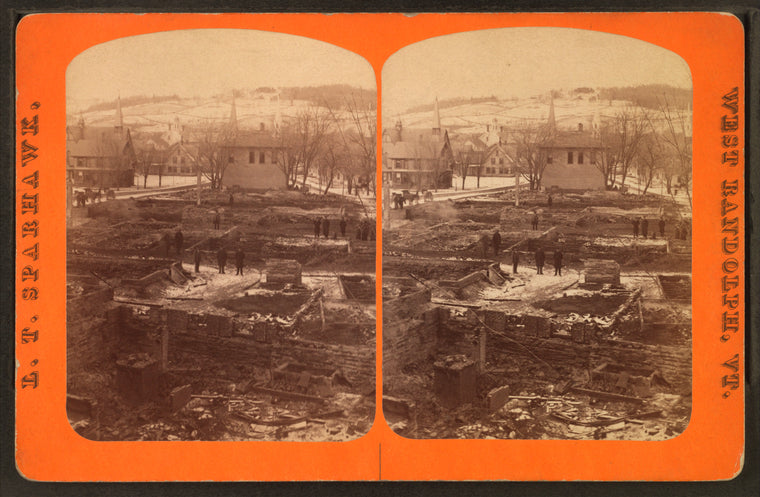 View of men standing among foundations of buildings (destroyed by fire?)
