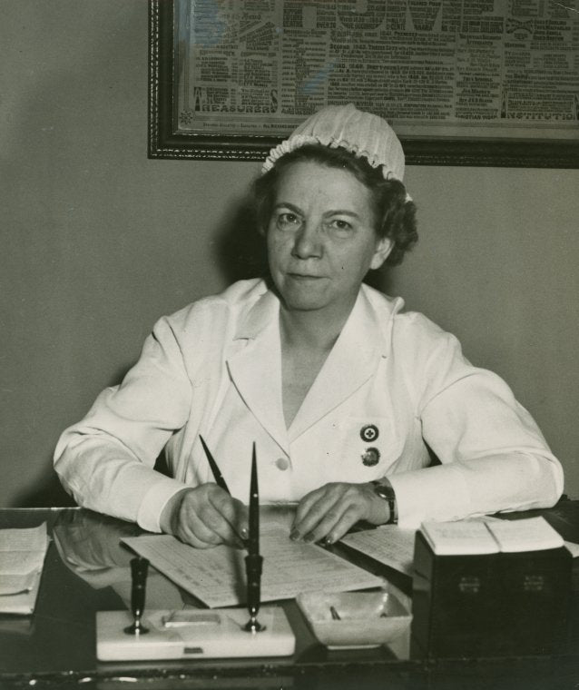 Portrait of L.G. Dennhardt seated at desk.