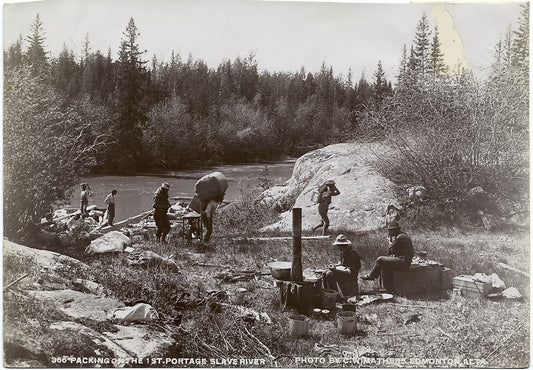 Packing on the first portage, Slave River.