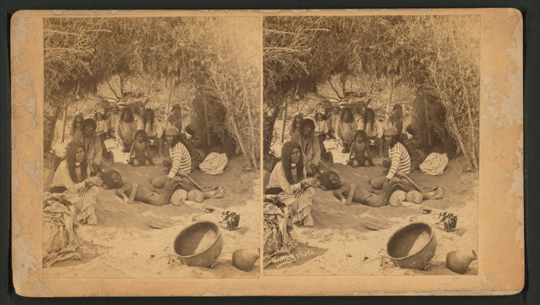 A group of Mohaves in a brush hut, one man very emaciated