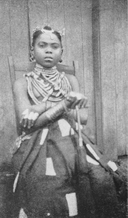 A Kru woman with "shield" finger-rings and hair ornaments