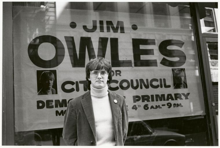 Jim Owles in front of campaign banner