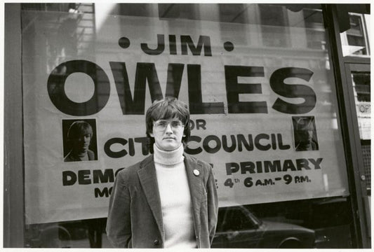 Jim Owles in front of campaign banner