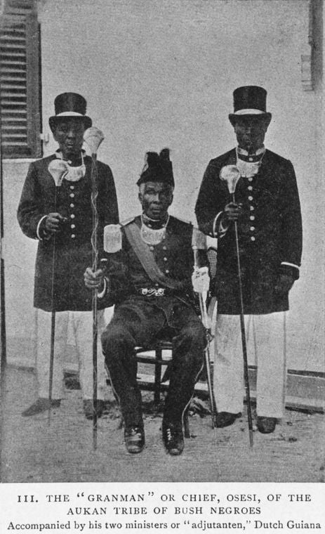 The "Granman" or Chief, Osesi, of the Aukan tribe of Bush Negroes; Accompanied by his two ministers or "adjutanten," Dutch Guiana.