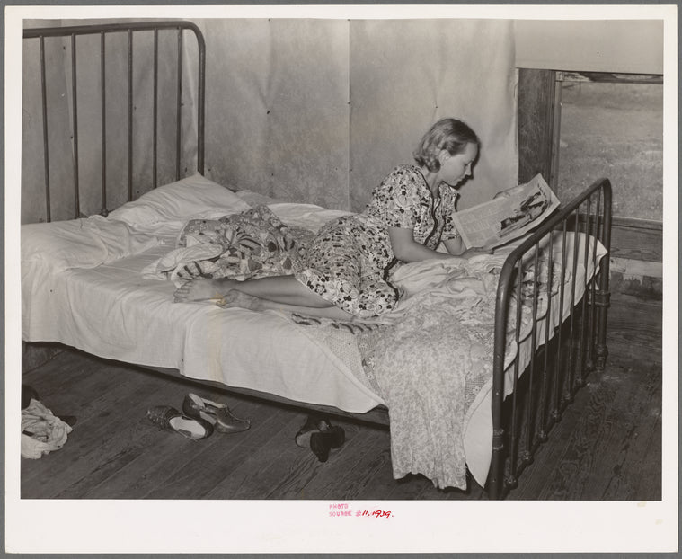 Daughter of woman tenant farmer reading magazine. Near Sallisaw, Oklahoma