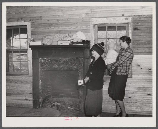 Mrs. Harvey and a neighbor watching her belongings being moved out of her house in the Camp Croft area near Whitestone, South Carolina.