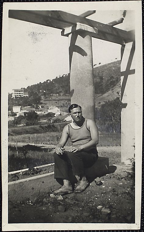 Richard Aldington seated on the base of a column