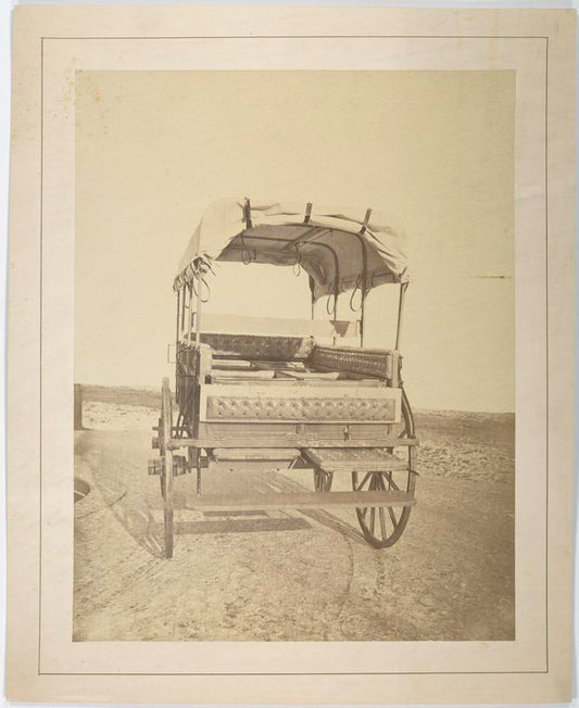 Howard ambulance, rear view, tailgate partially lowered, rollers that support cushioned litters are visible. Background masked.