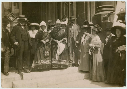 Members on the steps with women in local costume.