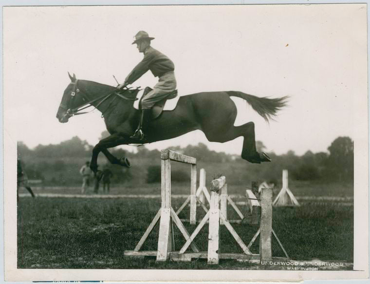 An Army officer demonstrating jumping with a cavalry remount